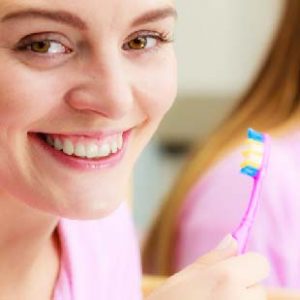 girl holding toothbrush